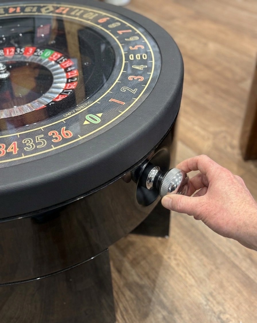 The Puller — a chrome knurled knob machined to fit the hand, drawn back to launch the ball